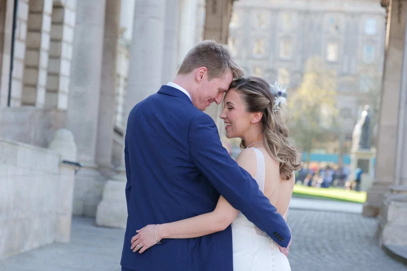 Couple holding each other outside Belfast City Hall